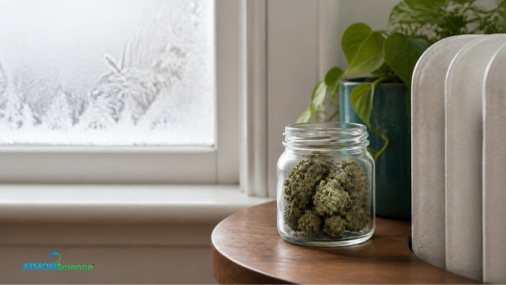 Glass jar of cannabis beside a radiator and frosted window, February jar drift in dry winter air