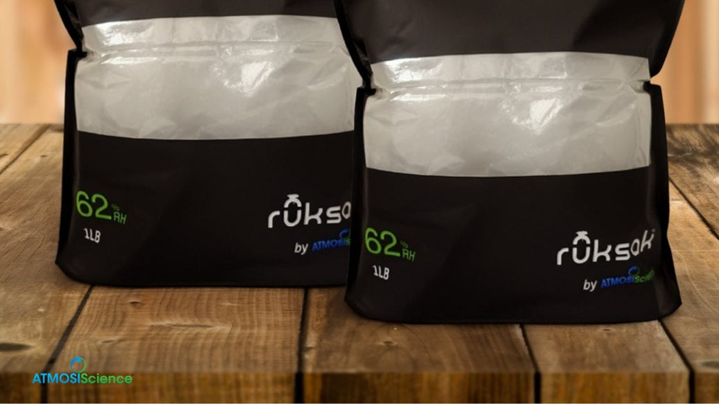 Two ruksak® 62% RH 1 lb bags on a wooden table, storage for a home-grown cannabis harvest