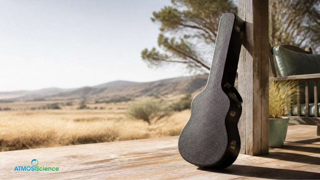 Acoustic guitar case on a sunny veranda in dry heat, acoustic guitar care for hot dry summers