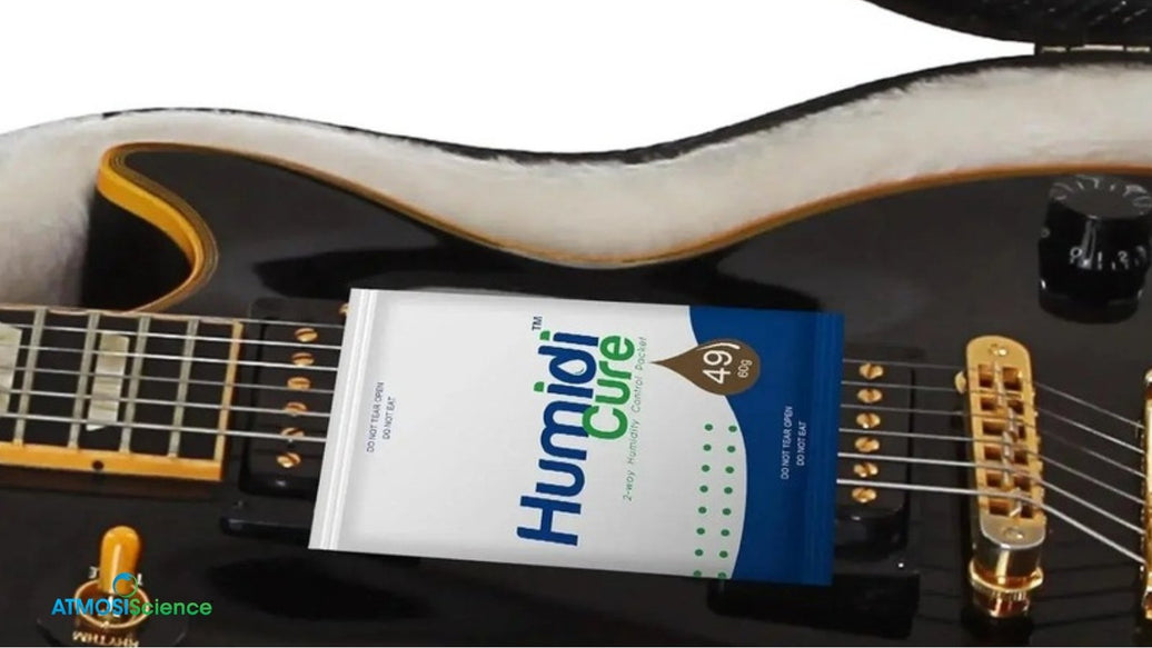 Humidi-Cure® 49% humidity pack on electric guitar strings in a case, checking humidity pack lifespan