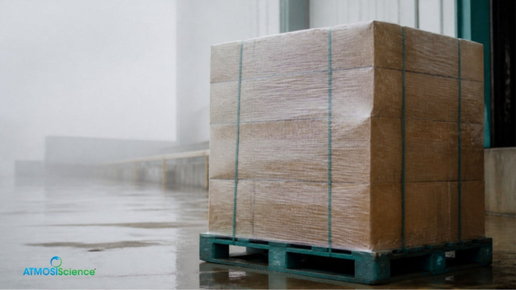 Stretch-wrapped pallet of cartons in a misty warehouse