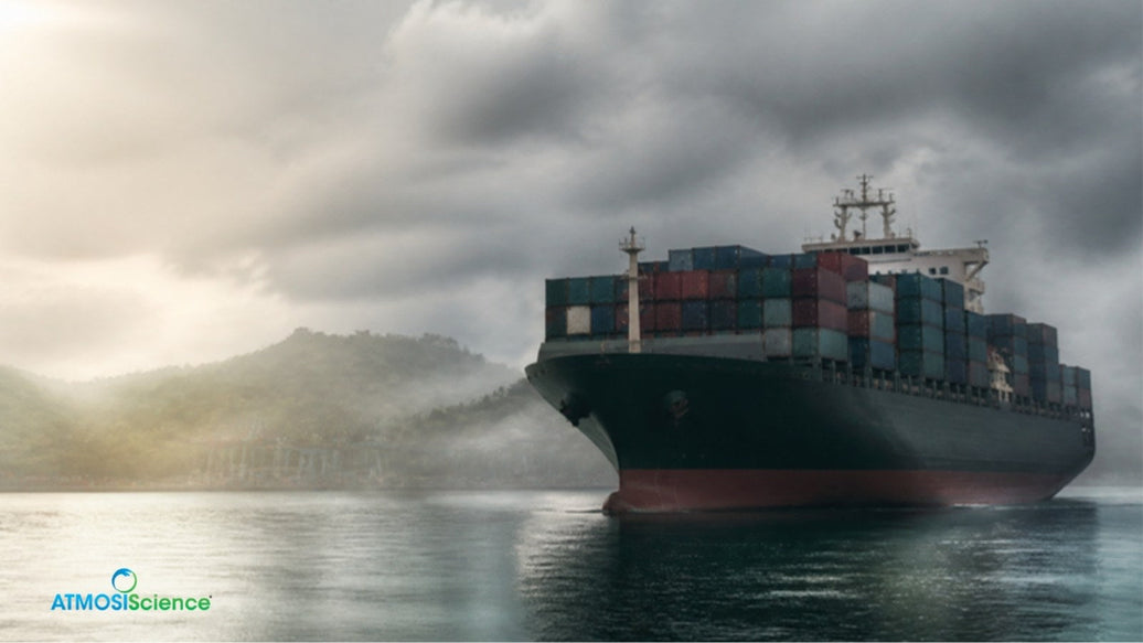 Loaded container ship at sea under heavy clouds