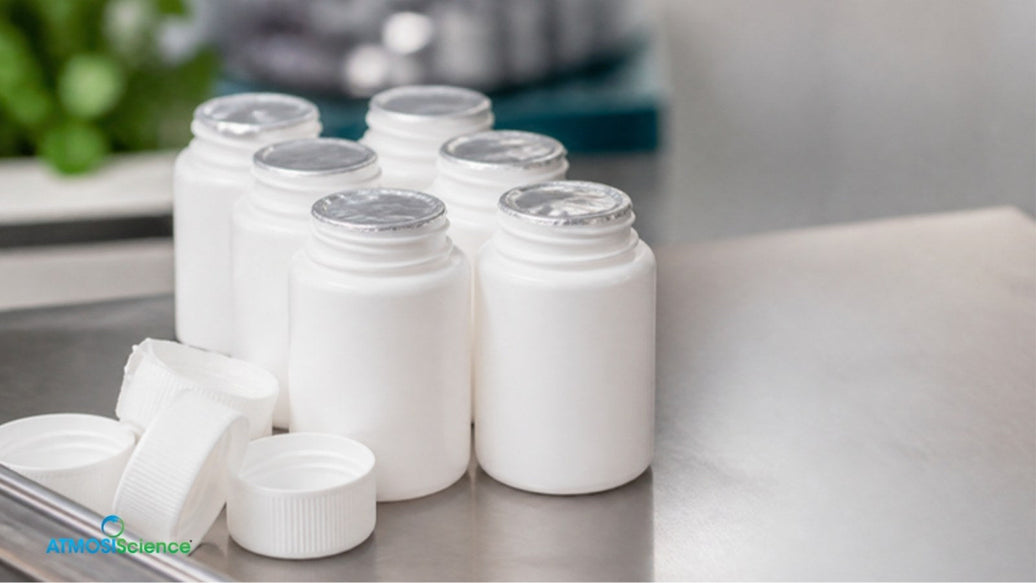 White supplement bottles and caps on a steel counter
