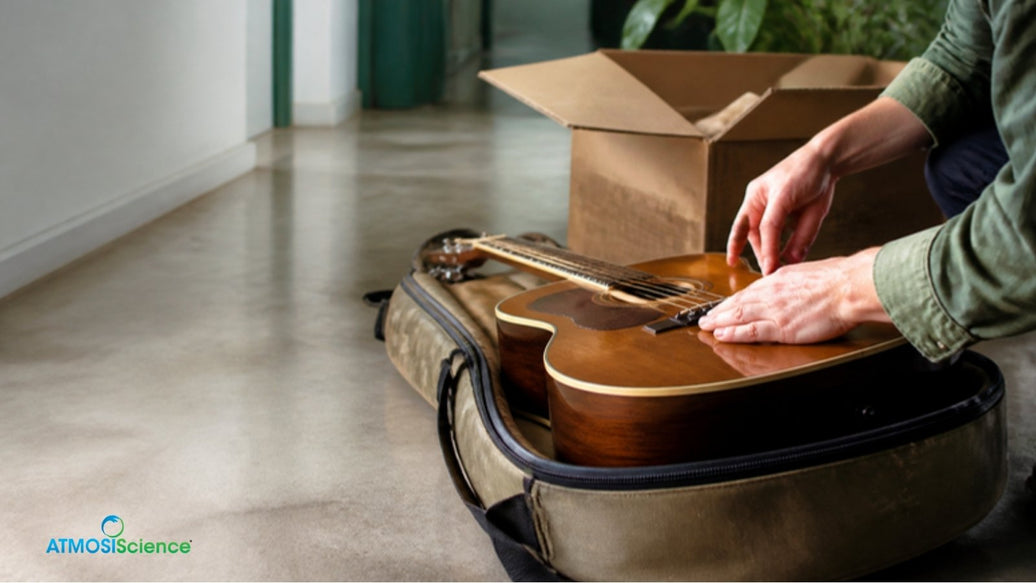 Hands inspecting a used acoustic guitar beside its shipping box, the first 48 hours after arrival